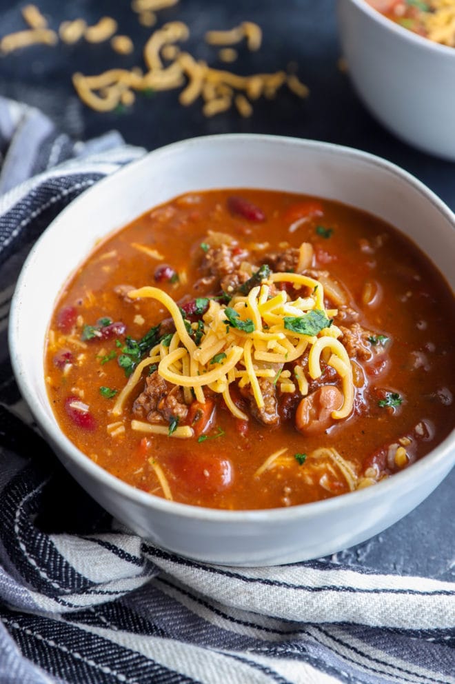 Chipotle beef and bean chili in a bowl with cheese