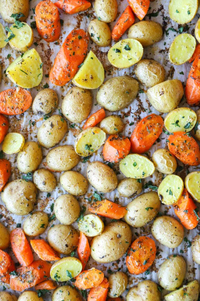 Overhead photo of potatoes and carrots on a sheet pan
