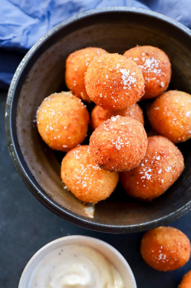 Bowl of fried cheese croquettes in a stack