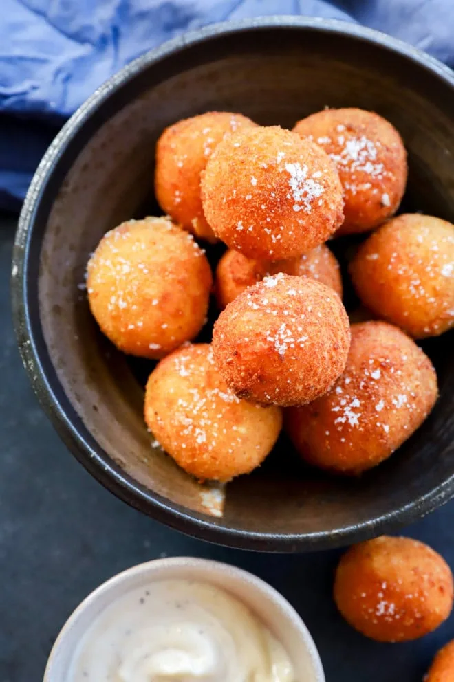Bowl of fried cheese croquettes in a stack