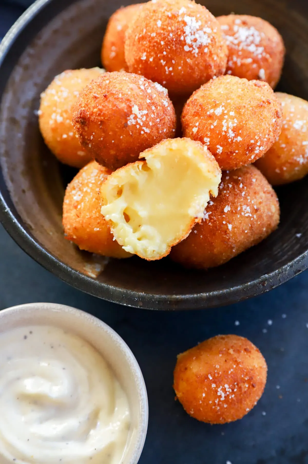 Cheesy croquette cut in half with gooey melted cheese inside