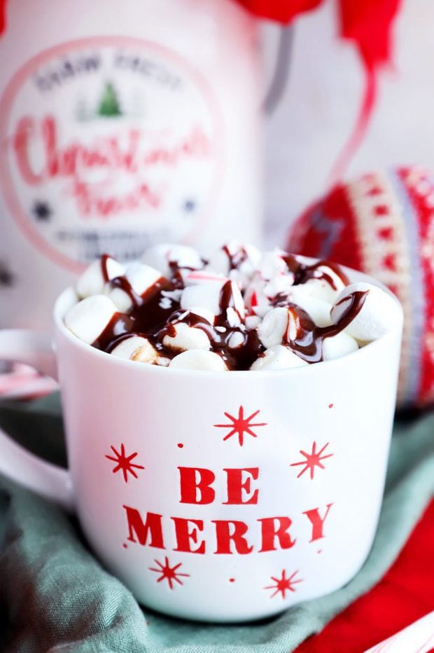 Side image of Be Merry mug with marshmallows