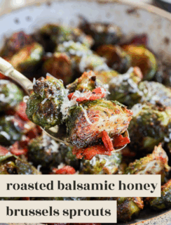 A close-up of roasted Brussels sprouts tossed with balsamic honey glaze, bits of bacon, and grated cheese, served in a rustic pan. Text overlay reads: roasted balsamic honey brussels sprouts.