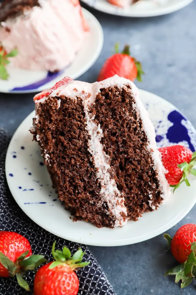 Slice of chocolate cake with strawberry frosting image