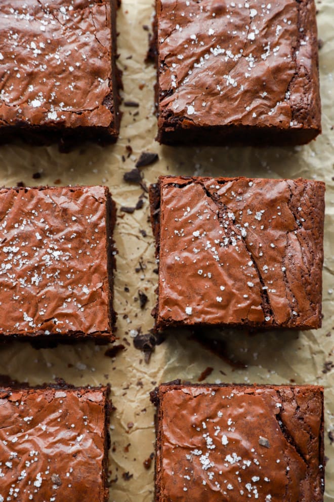 Triple chocolate brownies in lines on parchment paper