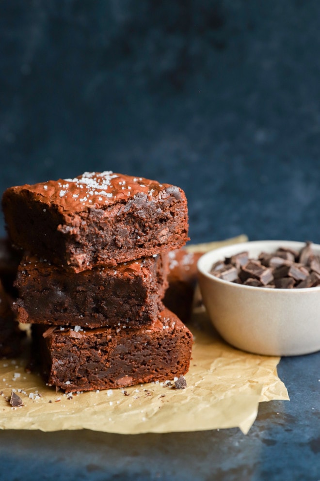 Stack of cocoa powder desserts on parchment paper