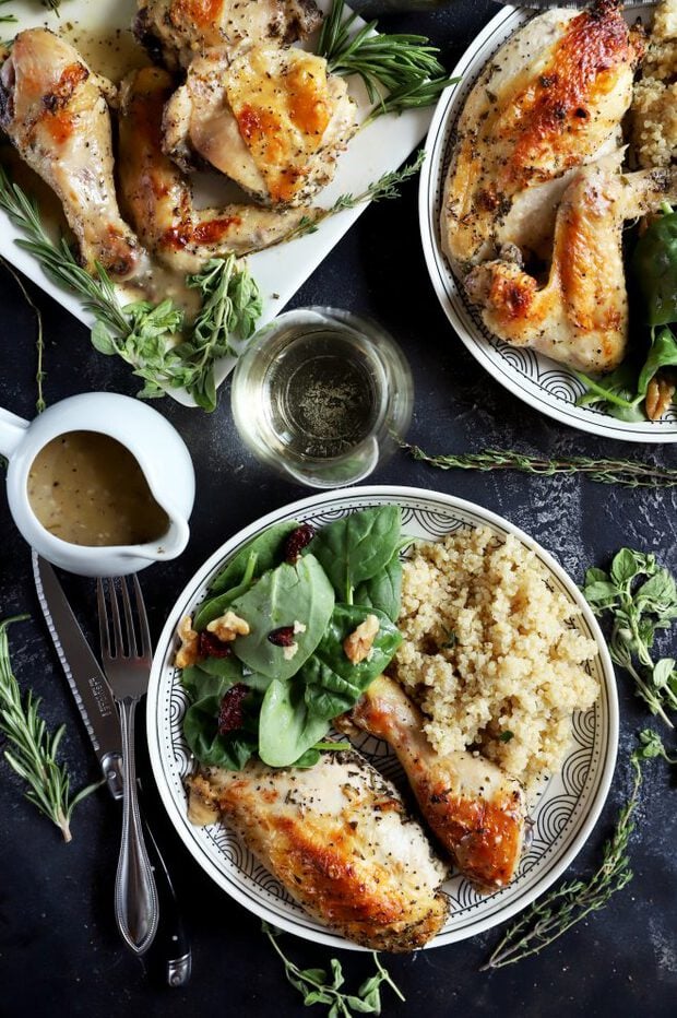 Chicken served on a plate with salad and quinoa