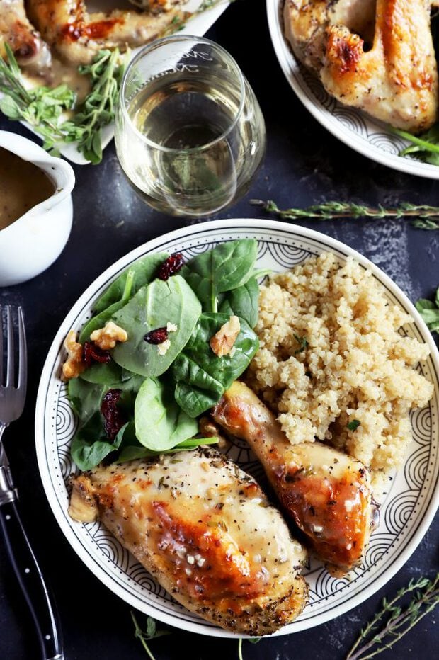 Roasted chicken on a plate with quinoa and salad