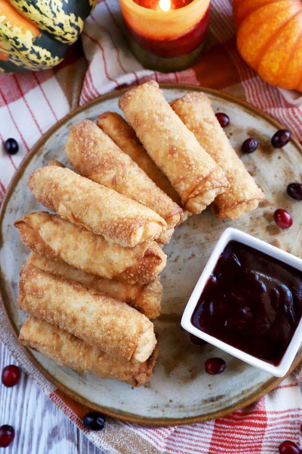 Egg rolls on a plate with dipping sauce image