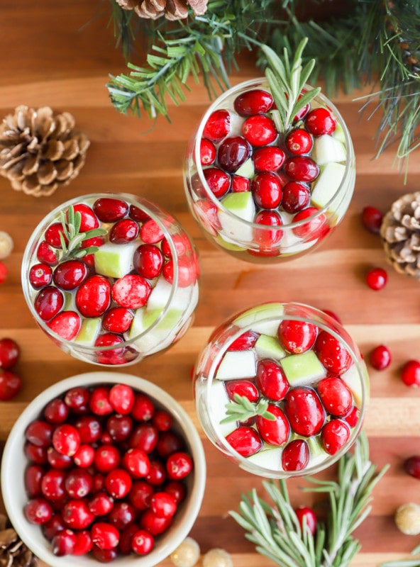 glasses of christmas sangria garnished with fresh rosemary