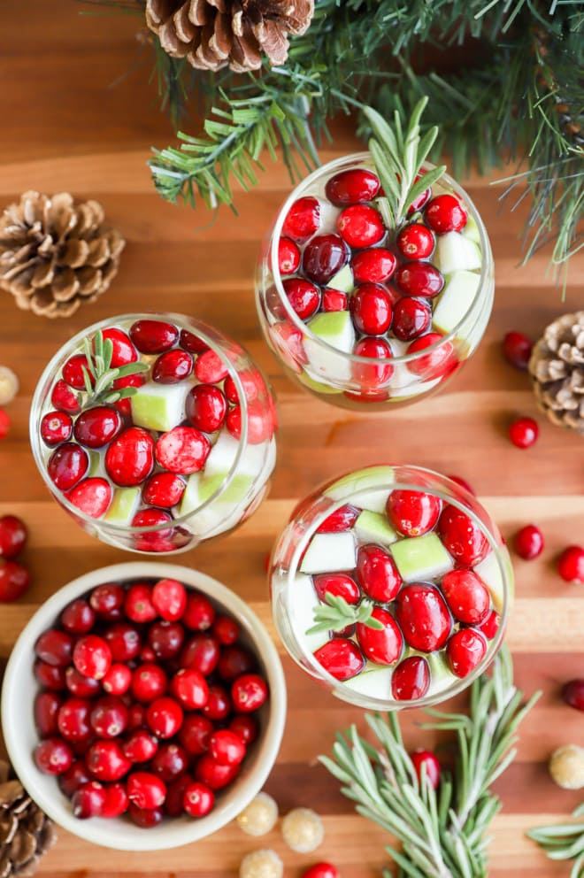 glasses of christmas sangria garnished with fresh rosemary