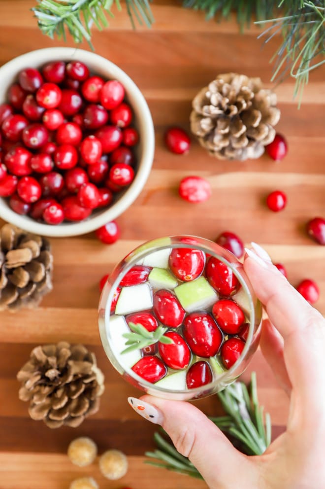 hand holding a glass of a holiday wine cocktail