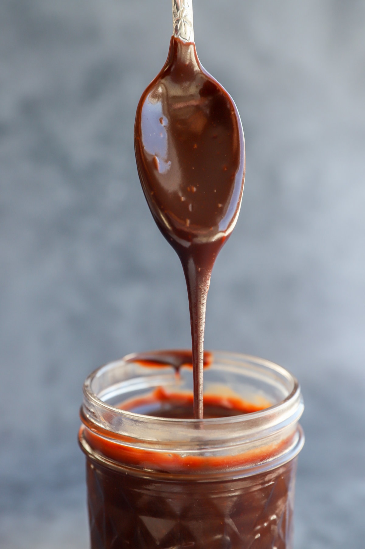 drizzling chocolate sauce into a jar image
