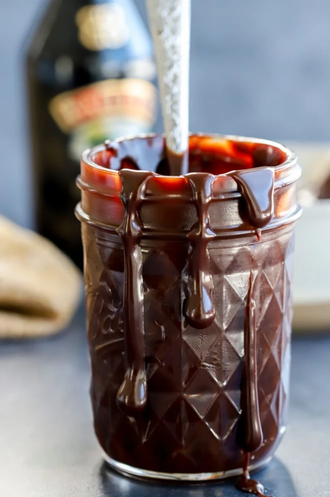 Baileys hot fudge sauce in jar with spoon