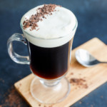 classic Irish coffee in clear mug with topping