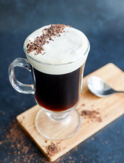 classic Irish coffee in clear mug with topping