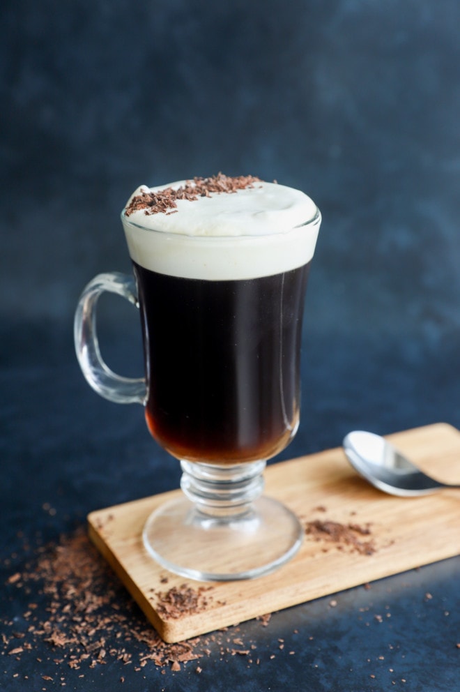 Irish coffee on cutting board with chocolate shavings on top