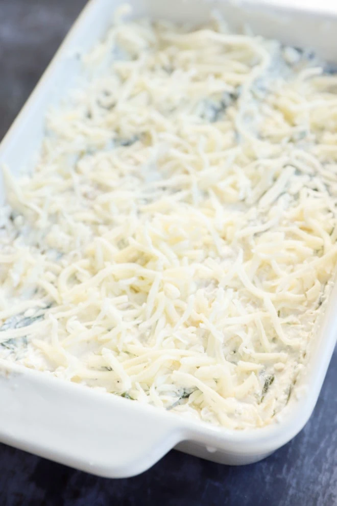 unbaked spinach artichoke goat cheese dip in dish image