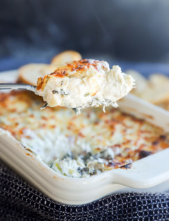 hot spinach artichoke goat cheese dip on spoon