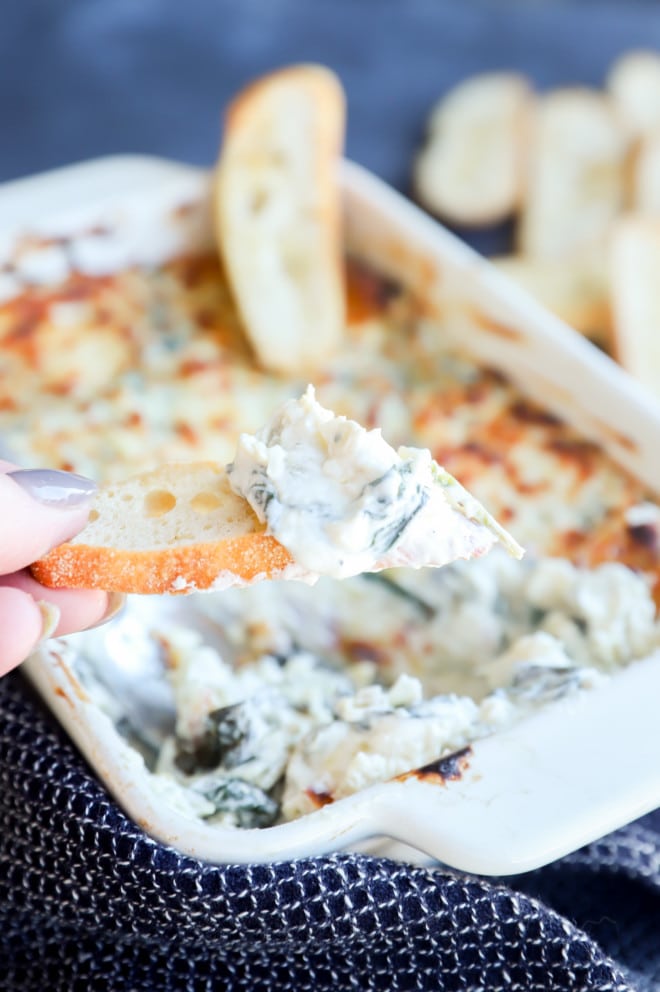 Spinach artichoke goat cheese dip on bread