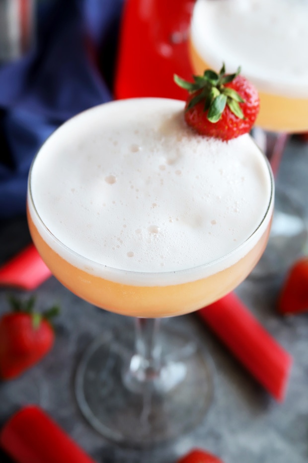 Strawberry Rhubarb Gin Fizz Cocktail in a coupe glass for April