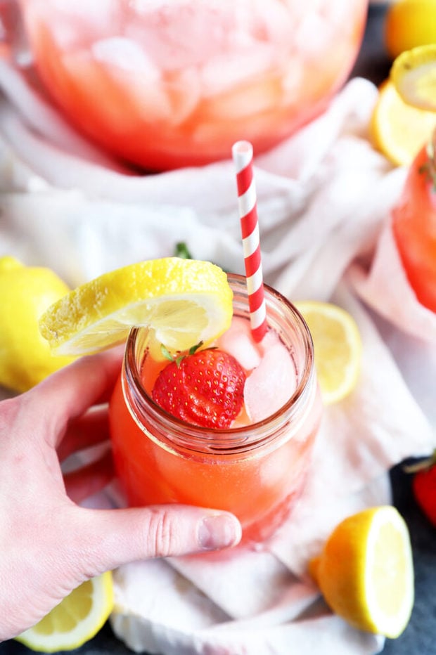 Image of hand holding vodka strawberry lemonade photo