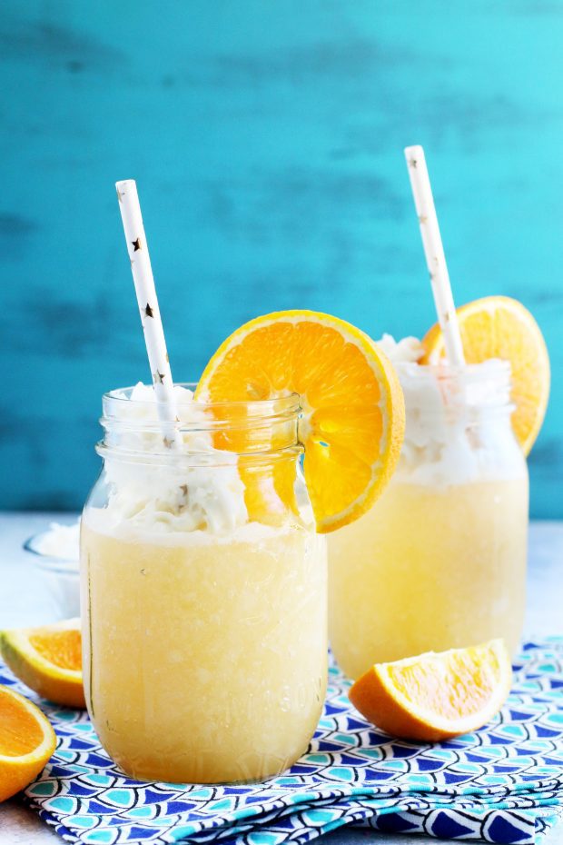 Orange cocktail with whipped cream vodka and whipped cream
