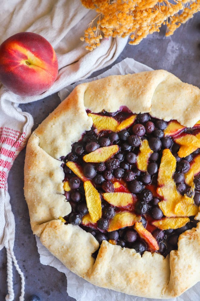 Overhead image of peach galette with blueberries
