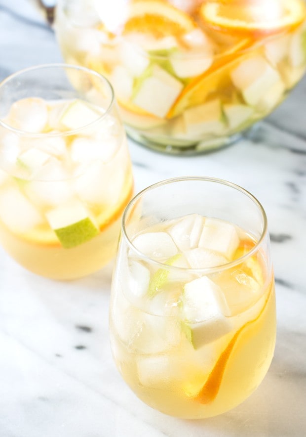 White summer sangria in wine glasses with ice