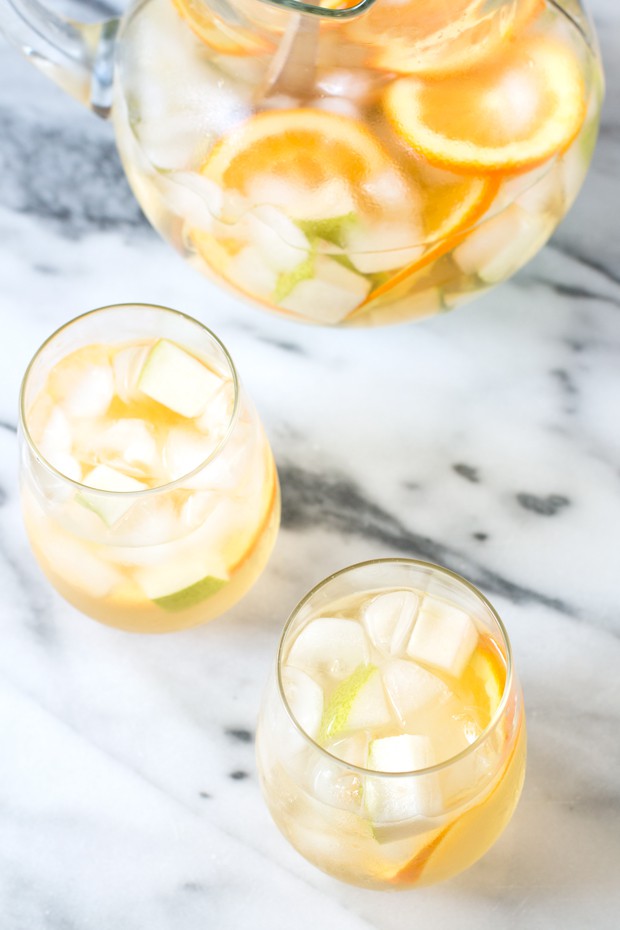Glasses of Pear Ginger White Sangria with fresh pear and orange slices