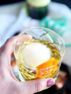 Hand holding old fashioned cocktail image