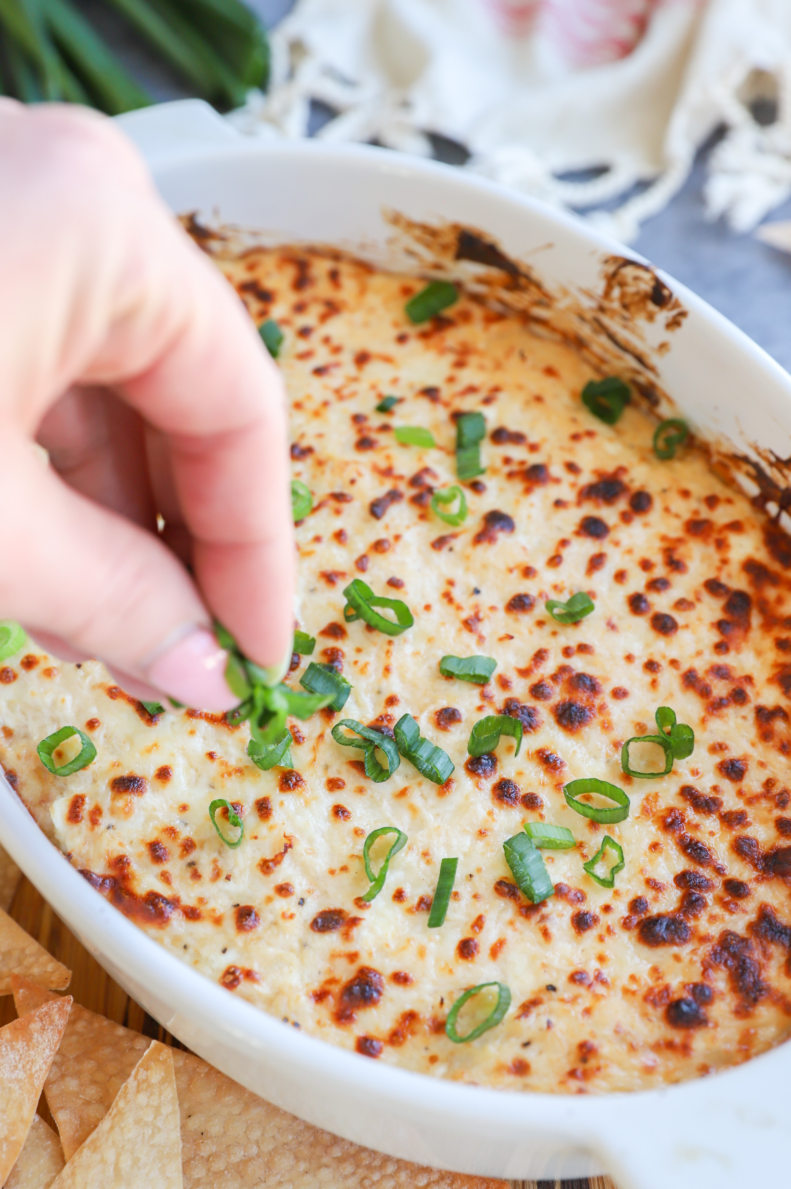 Garnishing cheese dip with green onions image