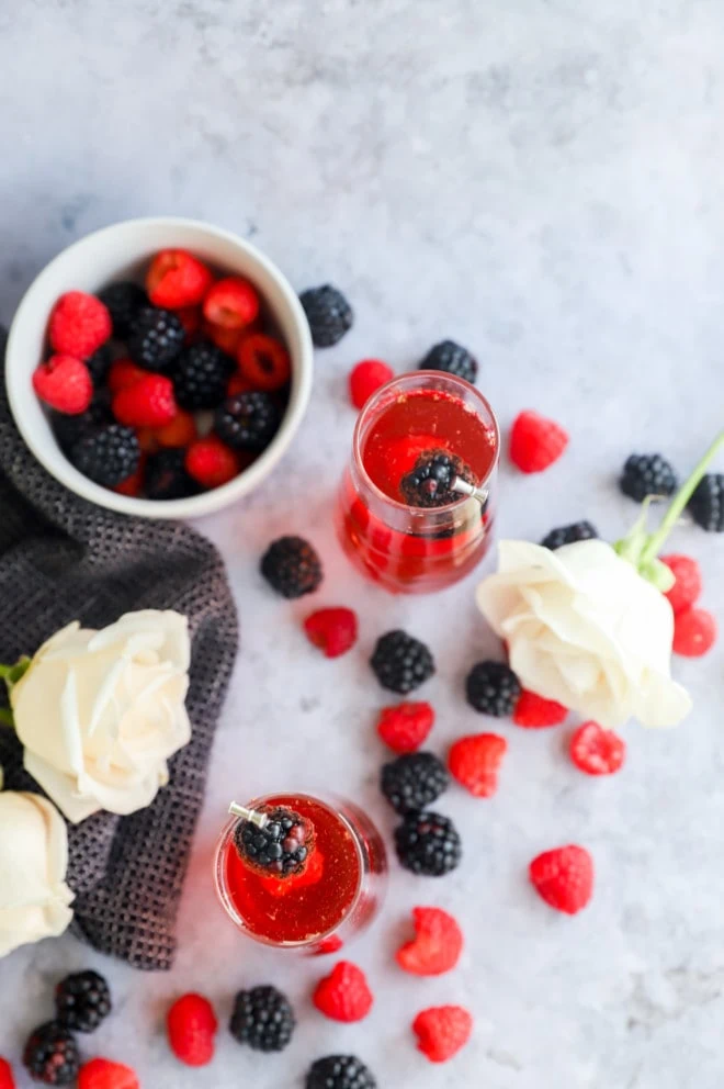 Image of sparkling rose cocktail with berries and white roses