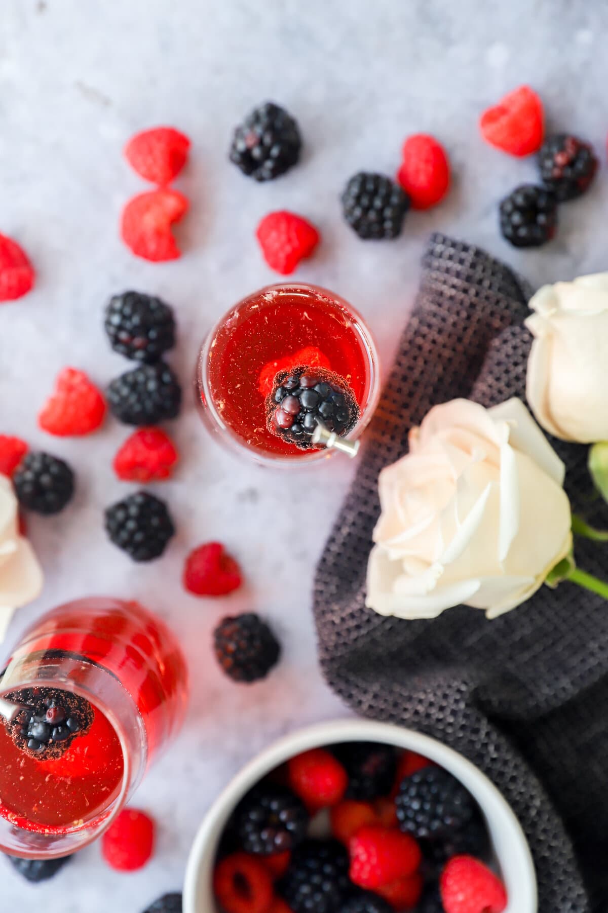 Flowers and a pink cocktail in champagne glasses