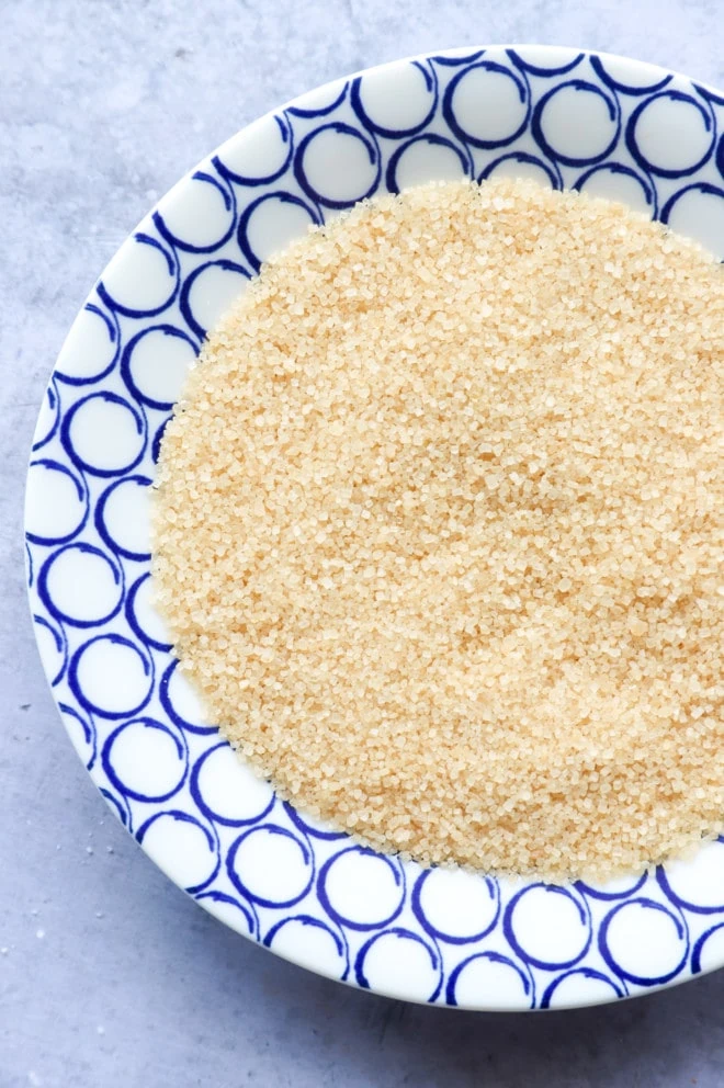 overhead image of raw sugar on plate