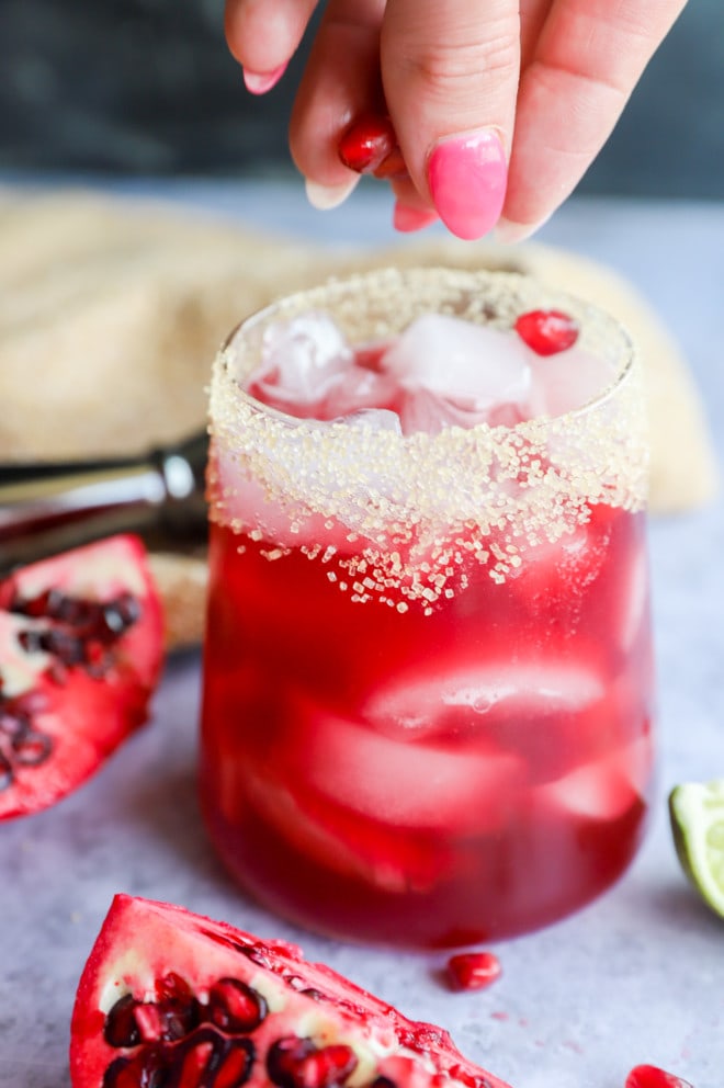 garnishing pomegranate margarita