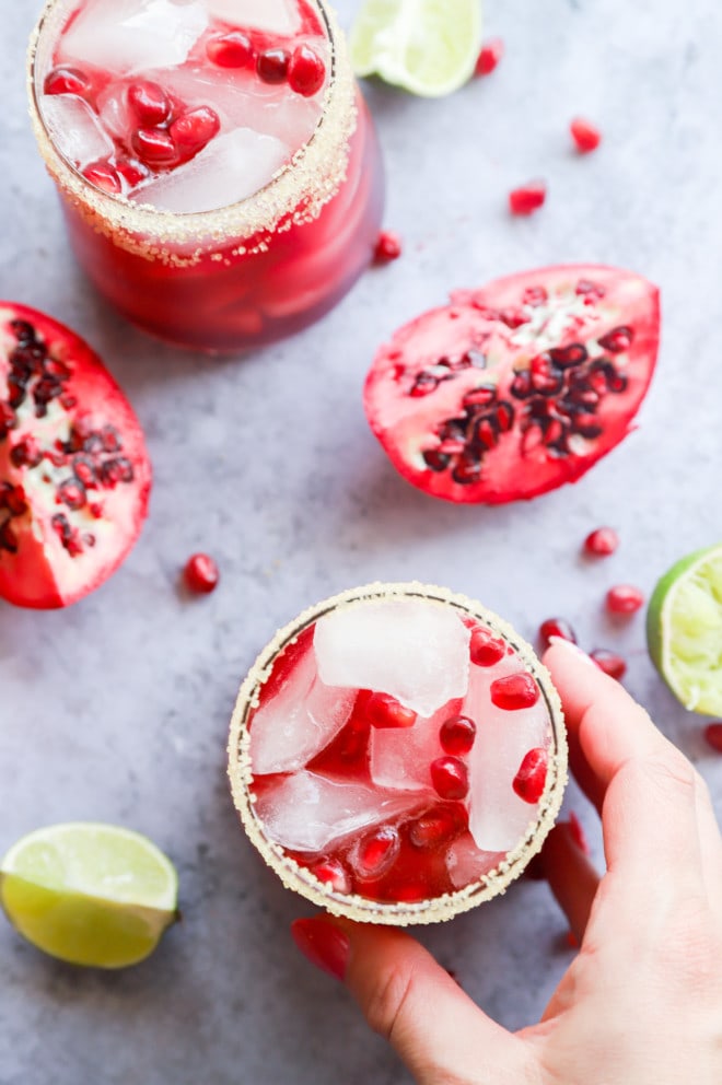 Hand holding pomegranate margarita image