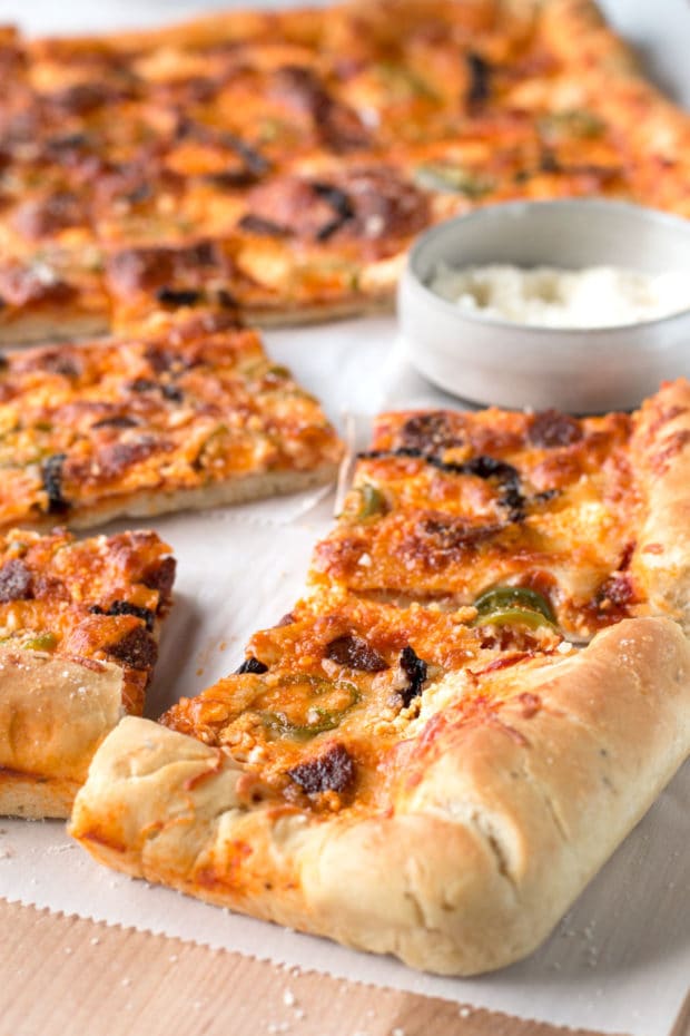 Pizza with smoked sausage, cherry tomatoes, dried chilli, jalapeno