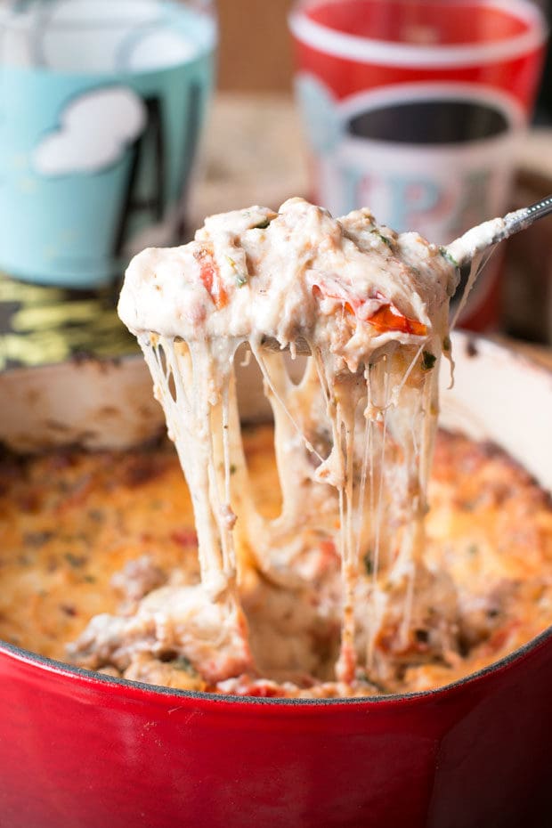 Spicy Lasagna Dip is packed with tomatoes, cheese, herbs and spicy Italian sausage. You won't miss the noodles at all! | cakenknife.com