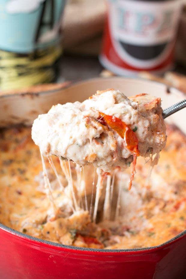 Spicy Lasagna Dip is packed with tomatoes, cheese, herbs and spicy Italian sausage. You won't miss the noodles at all! | cakenknife.com