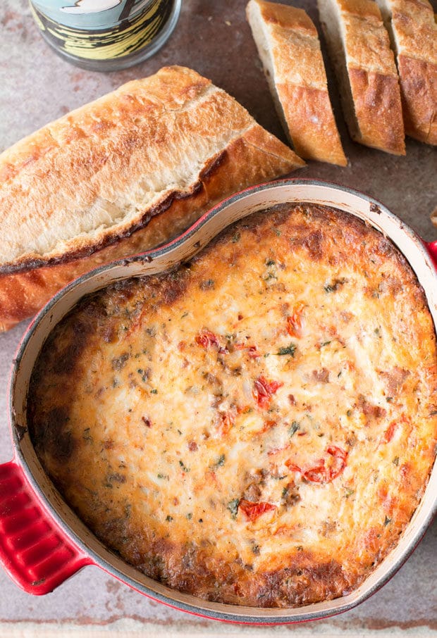 Spicy Lasagna Dip is packed with tomatoes, cheese, herbs and spicy Italian sausage. You won't miss the noodles at all! | cakenknife.com