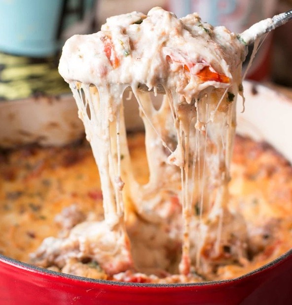 Spicy Lasagna Dip is packed with tomatoes, cheese, herbs and spicy Italian sausage. You won't miss the noodles at all! | cakenknife.com