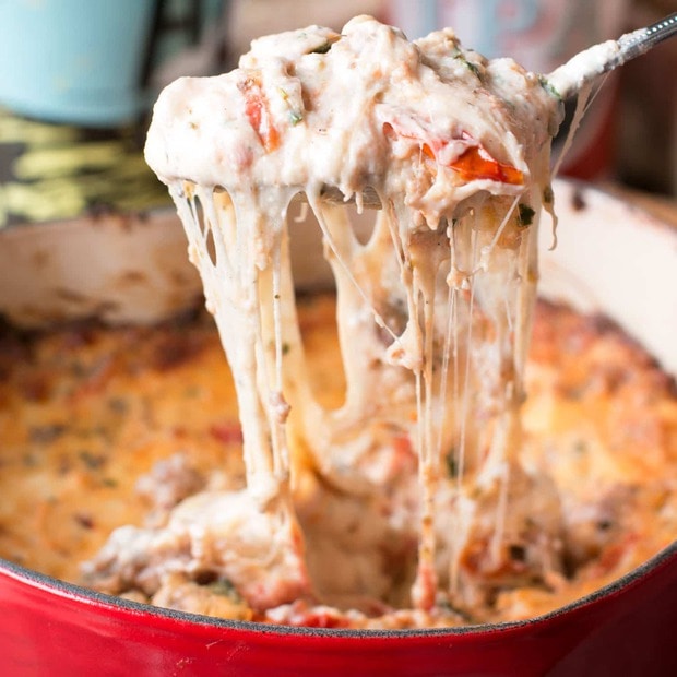 Spicy Lasagna Dip is packed with tomatoes, cheese, herbs and spicy Italian sausage. You won't miss the noodles at all! | cakenknife.com