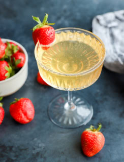 fresh fruit in a bowl with sparkling wine cocktail