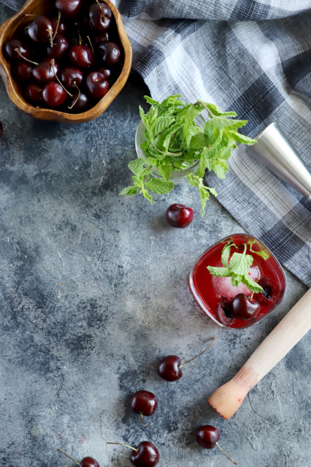 Overhead image of cherries and cocktail