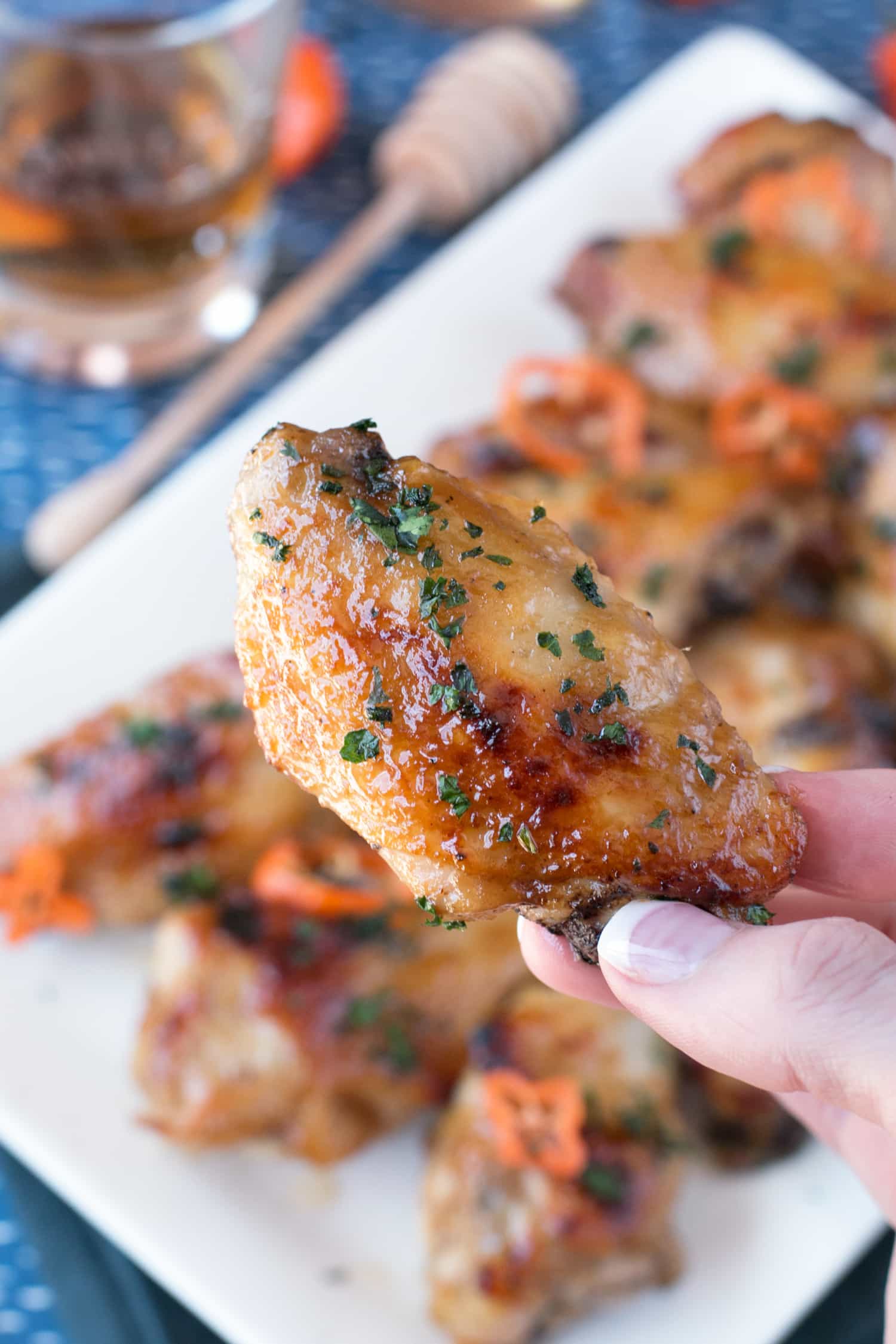 Delicious Bourbon Habanero Honey Chicken Wings on a wooden serving board