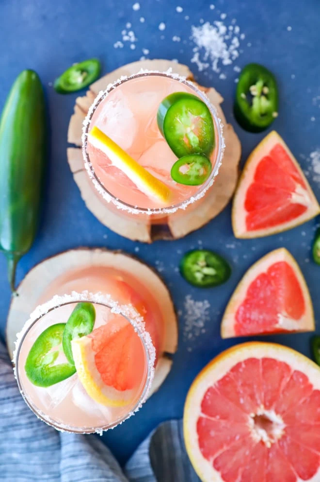 Overhead image of chili salty dog cocktails in glasses with fresh grapefruit