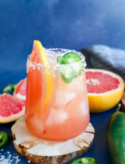 Grapefruit and fresh chili peppers in a glass with a drink