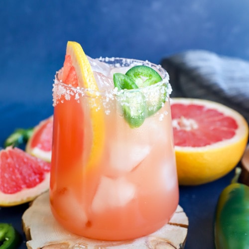 Grapefruit and fresh chili peppers in a glass with a drink