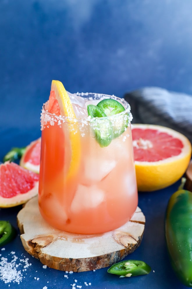 Grapefruit and fresh chili peppers in a glass with a drink